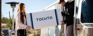 couple bringing new tochta mattress into their camper