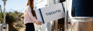 woman carrying new tochta mattress box