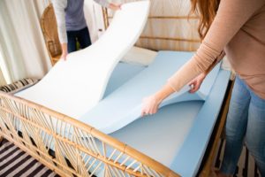 couple putting down foam layers in divini split mattress