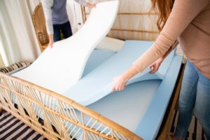 couple putting down foam layers in divini split mattress