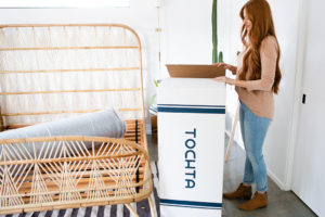 woman opening tochta mattress box