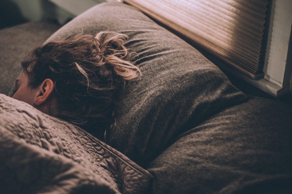 Sleeping girl on gray mattress