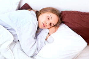 Female asleep in her comfortable custom mattress